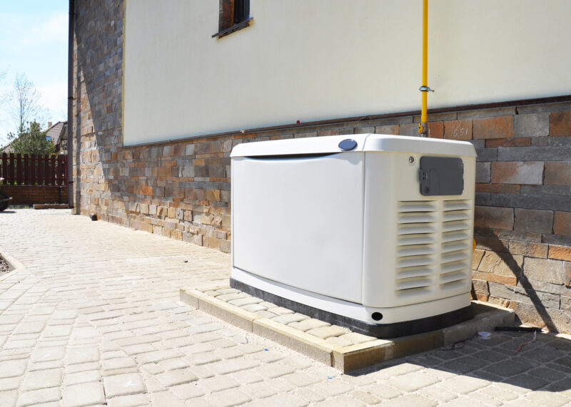 Residential standby generator installed on a patio